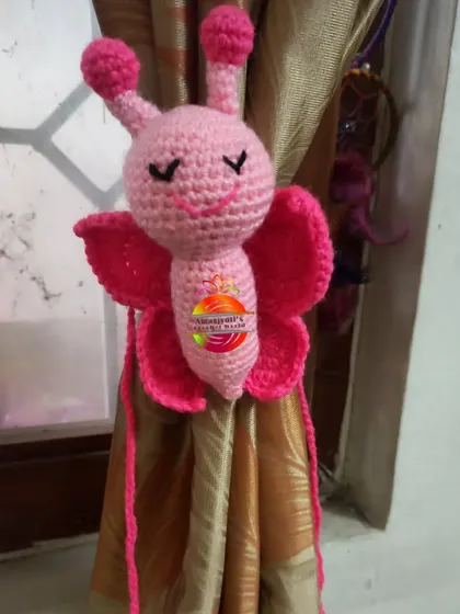 This adorable pink butterfly makes for a very cute curtain tie-back. The butterfly has stitched sleepy eyes and long ties that wrap around the curtain.