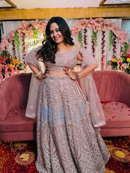 Another shot of the lovely pastel purple lehenga. The off-shoulder blouse and delicate embroidery make it a modern and stylish choice for any celebration.
