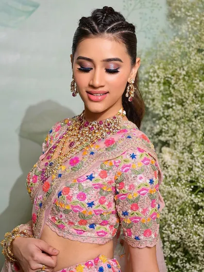 A modern bridal look with a chic braided ponytail. We teach both makeup and hairstyling to make you a complete artist.