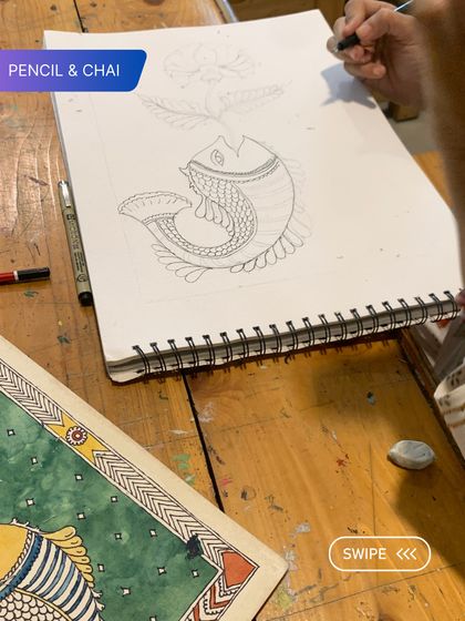 A student sketches a Madhubani fish, learning the foundational drawing skills that are essential before moving on to color.