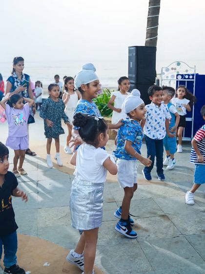 Kids dancing and having a great time with the ocean in the background, led by our party host and DJ.