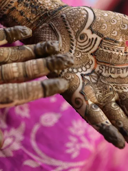 The intricate details of my bridal mehendi, with my husband's name hidden in the design. These small personal touches are what make a wedding so special.