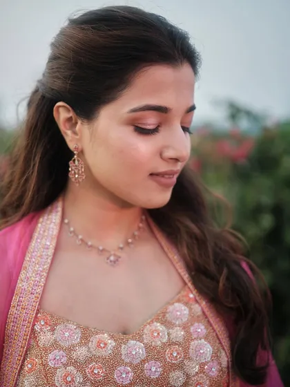 A close-up showing the soft and fresh eye makeup. The hints of pink and brown create a romantic and delicate look that enhances her natural beauty.