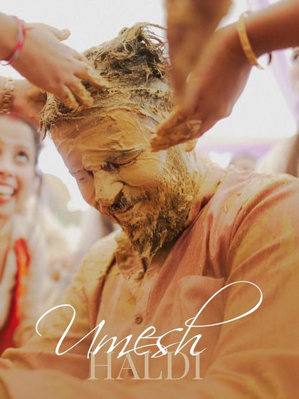 The groom smiles as he gets completely covered in haldi paste by his loved ones. We capture the messy, fun, and unforgettable moments.