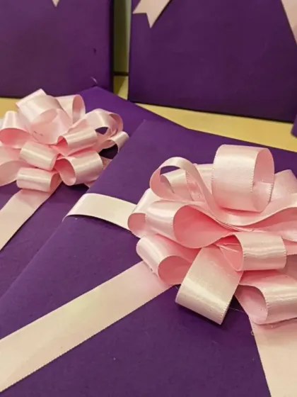 Simple yet elegant gift wrapping in purple with a delicate pink bow. This was part of a large order for a Women's Day event hosted by the Adani Foundation's Utthan initiative.