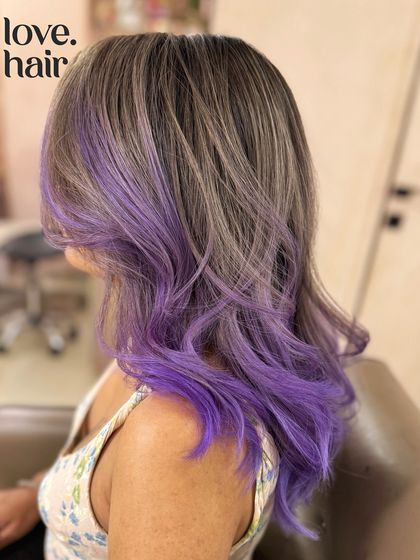 A side view of the ash brown and purple blend, showing how the purple is concentrated on the ends and around the face for a bold, framing effect.