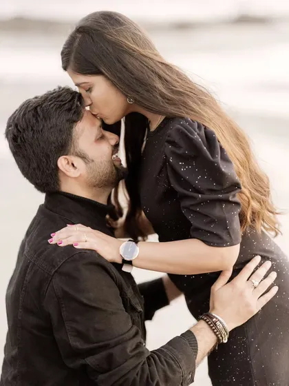 A sweet forehead kiss is a classic expression of love and care. This tender gesture makes for a timeless and heartfelt pre-wedding photograph.