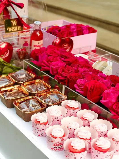 The delicious treats at our Valentine's stall, including cupcakes, brownies, and boxes of beautiful red roses.