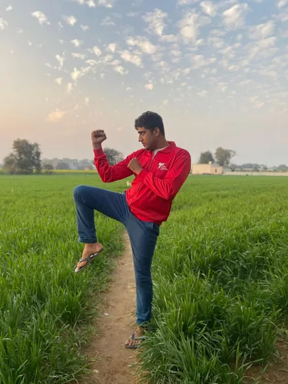 Connecting with nature while practicing a basic karate stance in a green field. The fundamentals are the most important part of the journey.