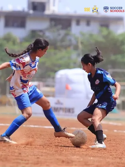 A duel for the ball featuring Prisha Patel. This image captures the competitive spirit and technical skill required to excel at the national level tournaments our players participate in.
