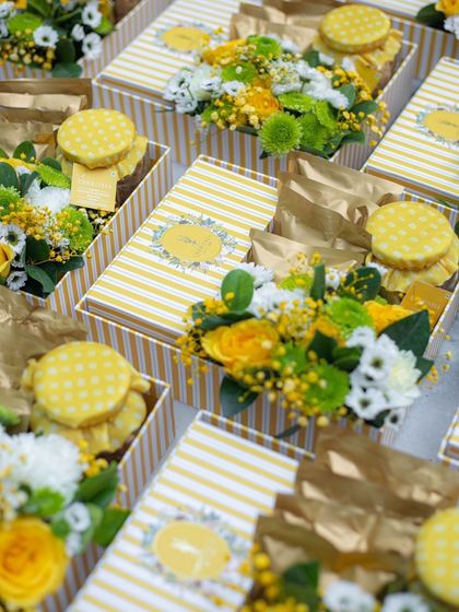 A sea of sunshine. These yellow-themed gift boxes, filled with our gourmet treats and fresh flowers, were prepared for a large bespoke order.