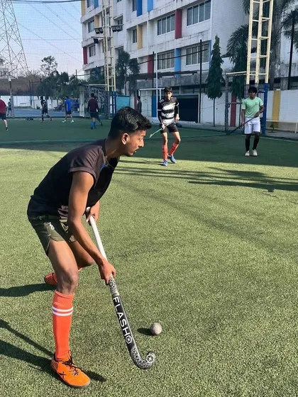 A player prepares to receive a pass during a Sunday morning practice. We focus on proper positioning and readiness.