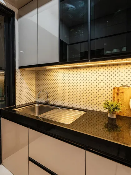 The sink area is just as important as the cooking zone. Here, the under-cabinet lighting continues, ensuring the entire countertop is well-lit for all kitchen tasks.