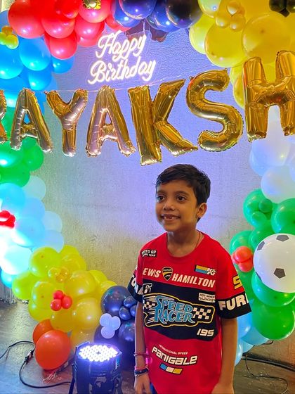 The happy birthday boy in front of his party decorations. We work alongside your theme to create a cohesive and exciting celebration.
