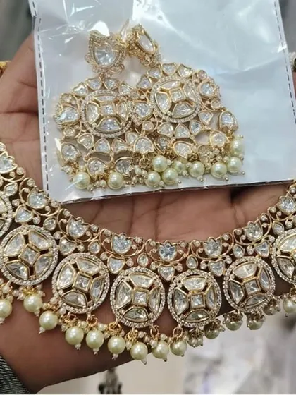 A classic uncut Kundan necklace with matching oversized earrings. This is a versatile rental set that can be worn for a wedding or a grand reception.