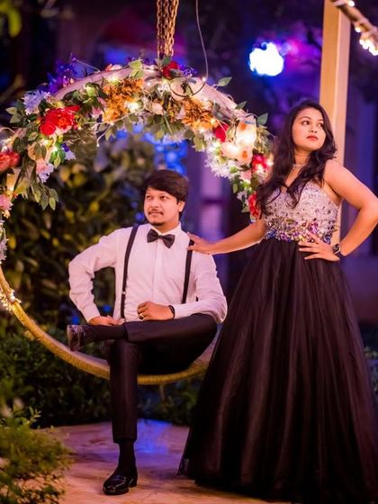 A glamorous nighttime pre-wedding shoot. The client's black sequin ball gown sparkles under the lights, creating a sophisticated and elegant look.