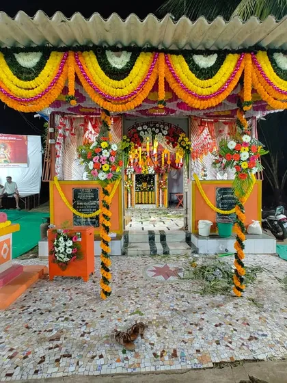 Another angle of the Maghi Ganpati pandal decoration in Charkop. The pillars are wrapped in floral garlands, and the entrance is heavily decorated to create a grand welcome for all visitors.