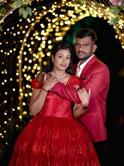 A happy couple posing in the light arch, a perfect setting for a classic pre-wedding photo.