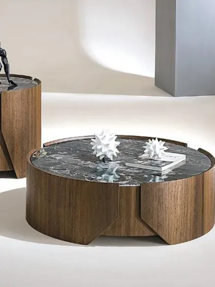 A modern coffee table set featuring a round center table and a matching cylindrical side table. Both have dark marble tops and rich wood-veneer bases.