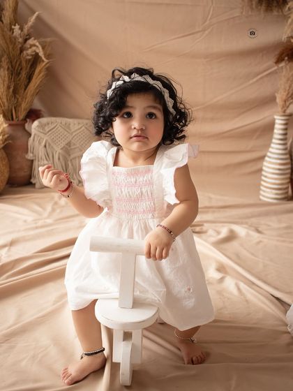 A simple and charming shot from a boho-themed session, featuring a classic wooden tricycle prop.