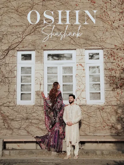 A stylish portrait of the couple against the ivy-covered wall of Woodville Palace. Their traditional outfits contrast beautifully with the heritage architecture.