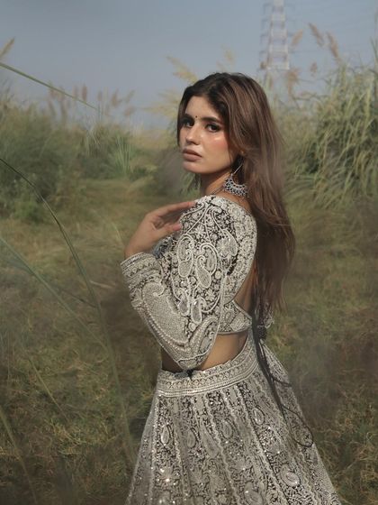 A close-up portrait in this stunning black and white lehenga, showcasing its intricate details.