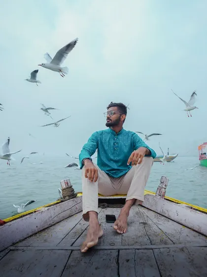A self-portrait on a boat in Varanasi, surrounded by seagulls. A peaceful memory from my travels in 2023.