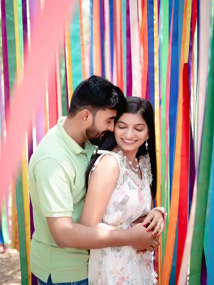 A close and happy embrace against the colorful ribbon backdrop. This shot is all about joy, color, and the connection between the couple.