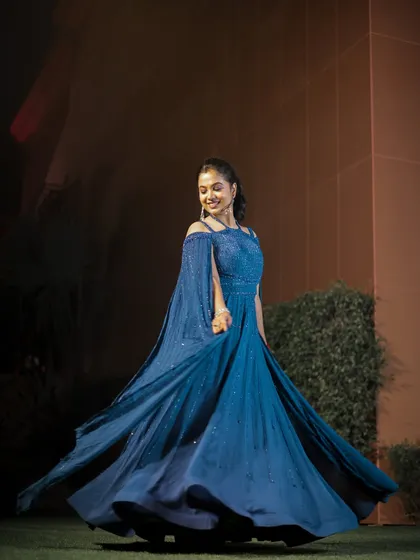 The bride, Somya, twirls in her stunning blue engagement gown. I love capturing these dynamic shots that show off the movement and detail of the outfit.