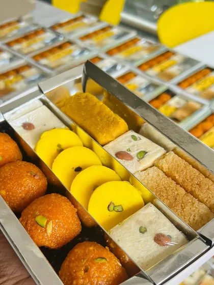 We believe in letting you build the perfect gift. This is an example of a custom-assorted sweet box, featuring a handpicked selection of Motichoor Ladoos, Pedas, and Barfis, ready to be shared.