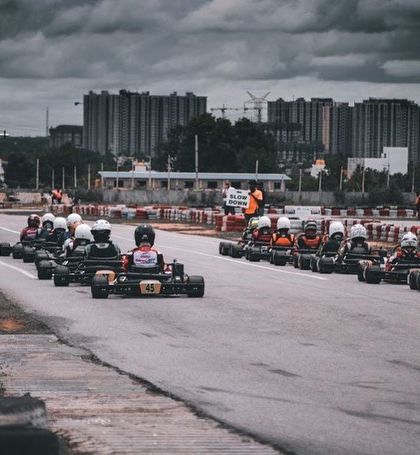The view from behind the starting grid at the National Karting Championship. The tension and anticipation are palpable as drivers prepare to launch.