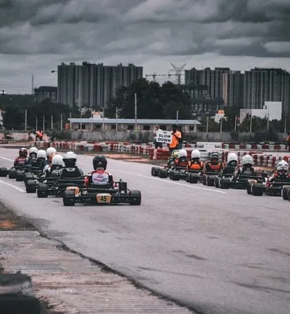 The starting grid for the National Karting Championship, with the city skyline in the background.