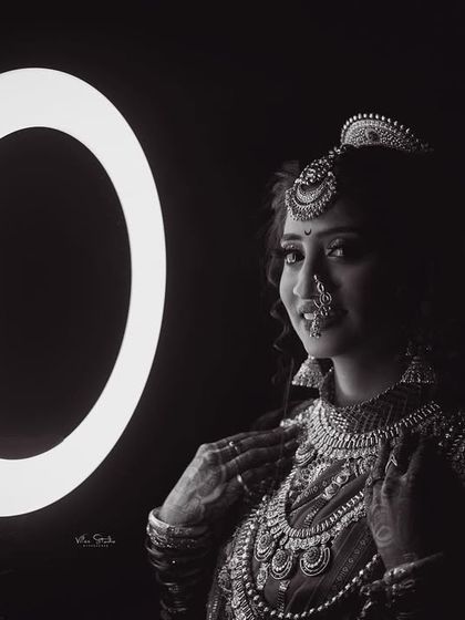 A dramatic black and white bridal portrait using a ring light. The high contrast and focused light create a moody and sophisticated image that highlights the bride's features and jewellery. (Duplicate of 108)