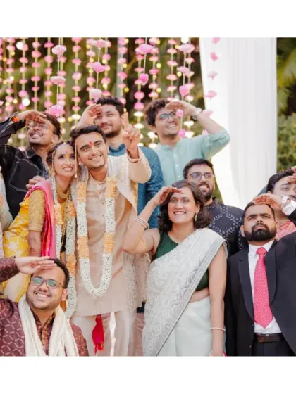 A fun group photo with the couple and their friends, all striking a playful pose. This shot captures the joy and support of their community during the Marathi wedding.