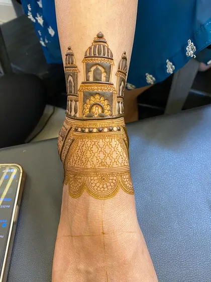 My designs aren't just for hands. Here is a beautiful architectural mehndi design on the ankle, showing the rich, dark stain that develops from my natural henna paste.
