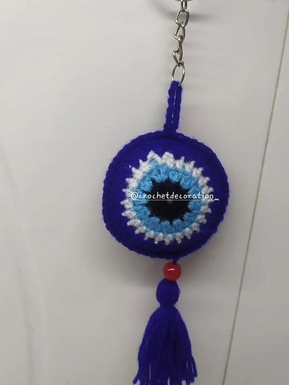 Our classic round crochet evil eye keychain, complete with a matching tassel. This protective charm is a popular gift to wish someone well and keep them safe from negative energy.