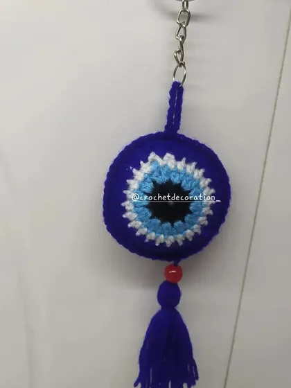Our classic round crochet evil eye keychain, complete with a matching tassel. This protective charm is a popular gift to wish someone well and keep them safe from negative energy.