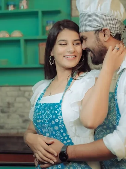Love is cooking up something beautiful! This couple shares a laugh in a quirky kitchen setting, a perfect example of a themed pre-wedding shoot that reflects shared interests and creates fun, natural interactions.