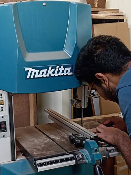 Nihal using the bandsaw to cut the cheeks of a tenon. The bandsaw is great for making quick and repeatable cuts.