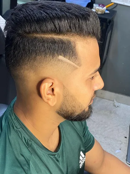 Modern grooming is about personal style. This high fade is accented with a sharp, razored line, adding a custom touch that makes the haircut unique while keeping the overall look clean and professional.