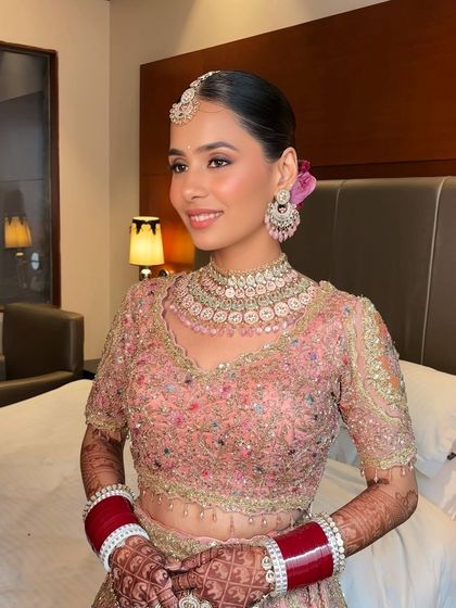 Harsheen's Anand Karaj look was breathtaking. Her intricately embroidered pastel lehenga was paired with a flawless base, soft pink eyeshadow, and a sleek bun adorned with a flower.