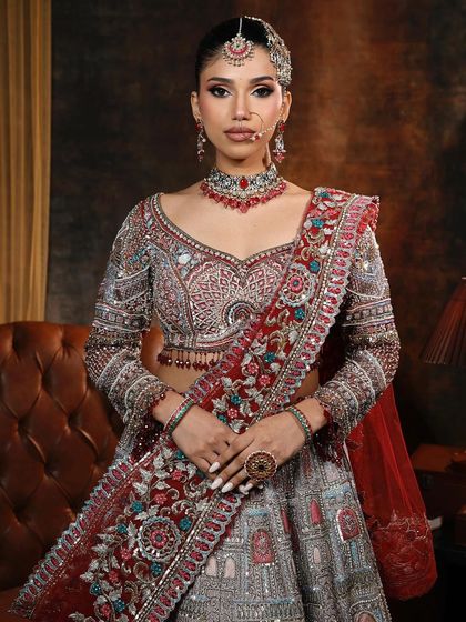 A full portrait of the regal glam bridal look. The makeup is sharp and defined, with a focus on sculpted features and dramatic eyes.