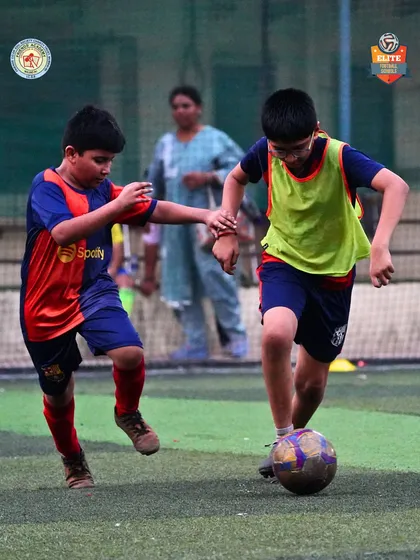 A tight battle for the ball showcases the competitive nature of the Friends' Cup tournament.