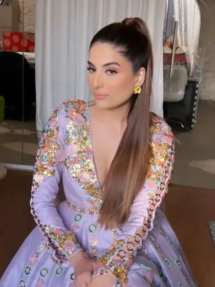 This shot shows the clean lines and polished finish of the high ponytail, a signature look for a sharp, contemporary aesthetic.