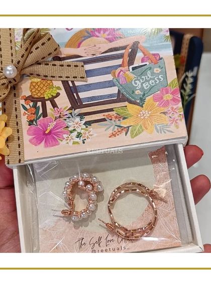 A cute slide-out box with a 'Girl Boss' design, containing a pair of stylish pearl hoop earrings for a birthday gift.