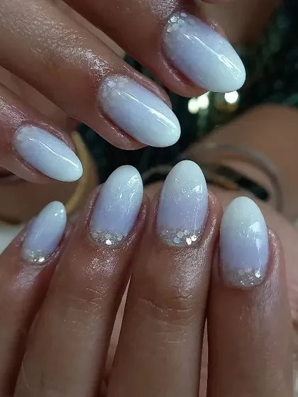 Another angle of the frosty ombre manicure, showing how the subtle glitter catches the light. This is a perfect choice for a winter event or a bridal look.
