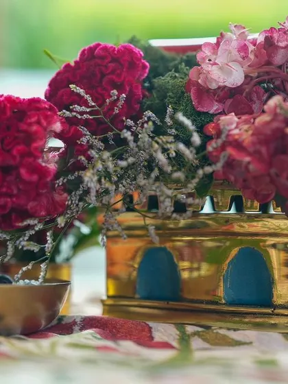 Another perspective of the brass lantern centerpiece, showing the intricate details and the play of light on the metal.