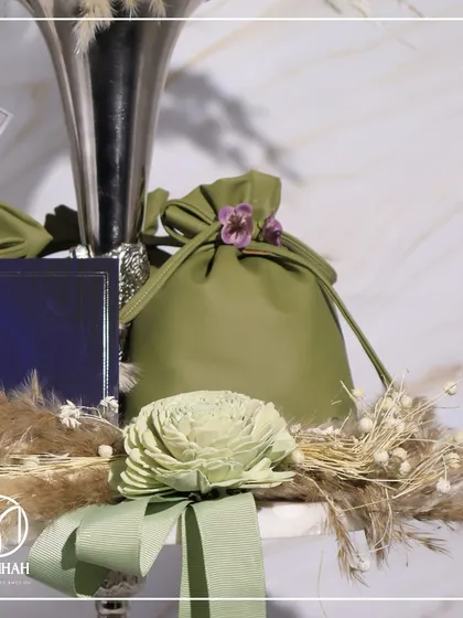 A close-up on the details of the invitation, including the custom tag and potli.