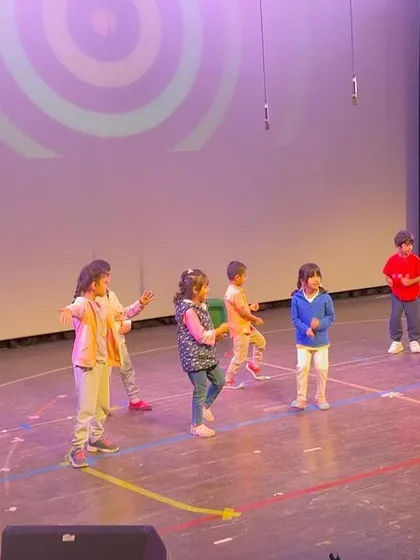 Another angle of the dance rehearsal, showcasing the colorful and dynamic energy of our young performers.