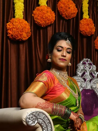 A complete look at Nirosha's engagement style. She wore a vibrant silk saree, and we created a soft glam look with a pretty pink lip and a chic updo.